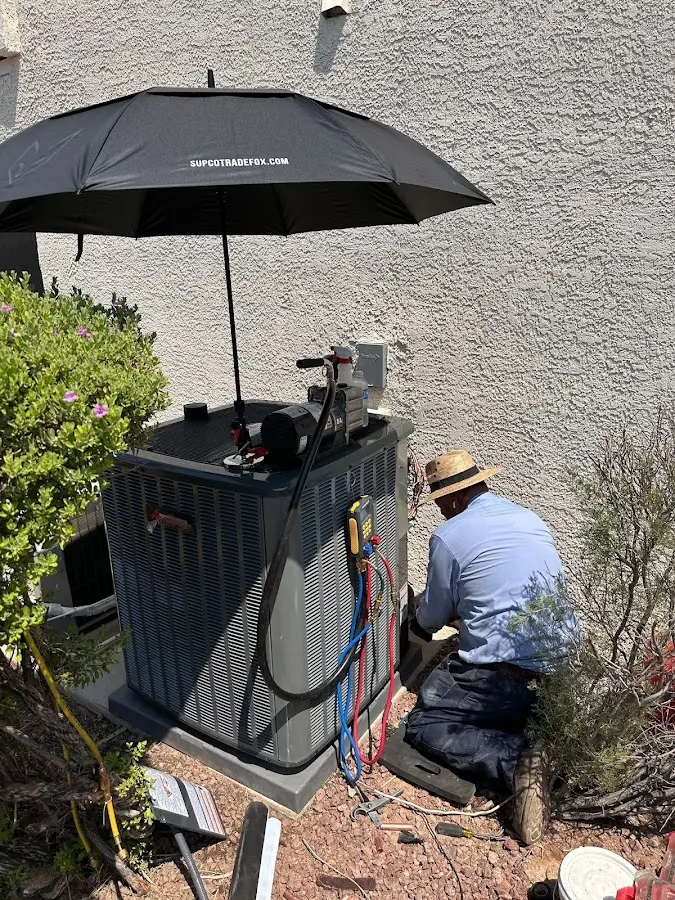 HVAC technician performing outdoor AC maintenance in West Lealman